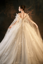 Elegant Off-Shoulder Ball Gown Wedding Dress with Tulle Cape & Bow Details