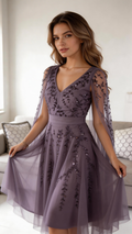 Woman in elegant lavender embroidered evening dress seated on sofa, ZAPDRESS fashion