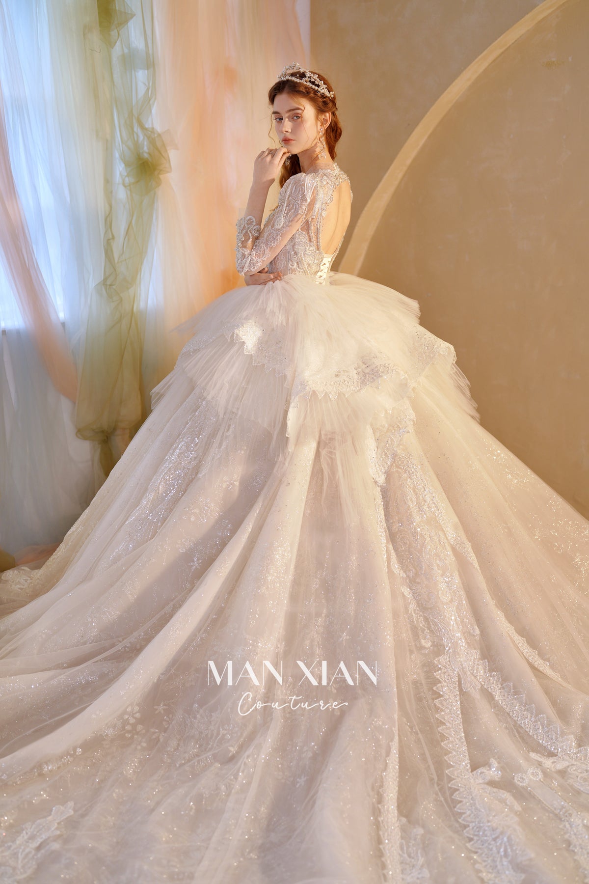 Abito da sposa etereo in tulle cristallino con scollo a V, maniche lunghe e strascico a cattedrale