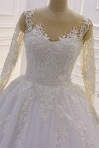 Hermoso vestido de novia largo de corte A con escote barco, apliques de tul perlado y encaje con mangas