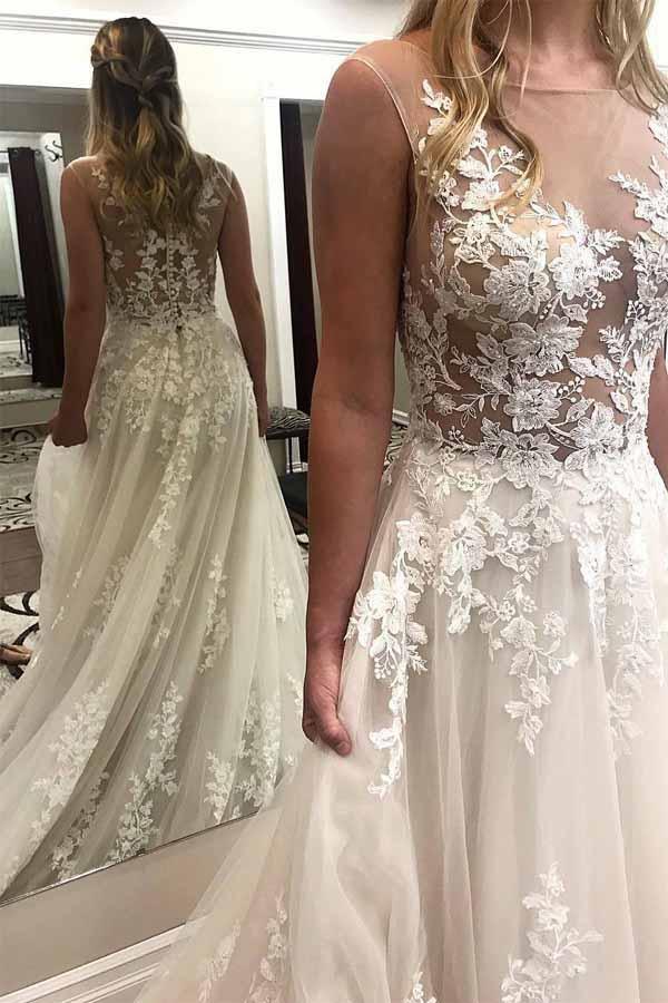 Vestidos de novia de encaje color marfil con apliques transparentes y cola de corte
