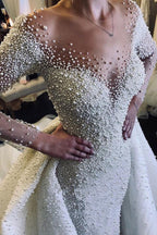 Abito da sposa con maniche lunghe avorio, scollo a V, bottoni, strascico spedibile e perle completamente ricoperte