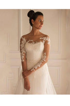 Vestido de novia estilo sirena con mangas largas, apliques, botones y largo hasta el suelo 