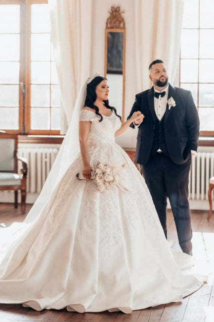 Lujoso vestido de novia blanco largo de satén con hombros descubiertos y encaje.
