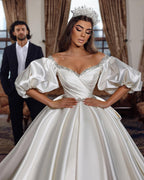 Vestido de novia princesa largo color marfil, corte A, escote en V, joya y mangas largas