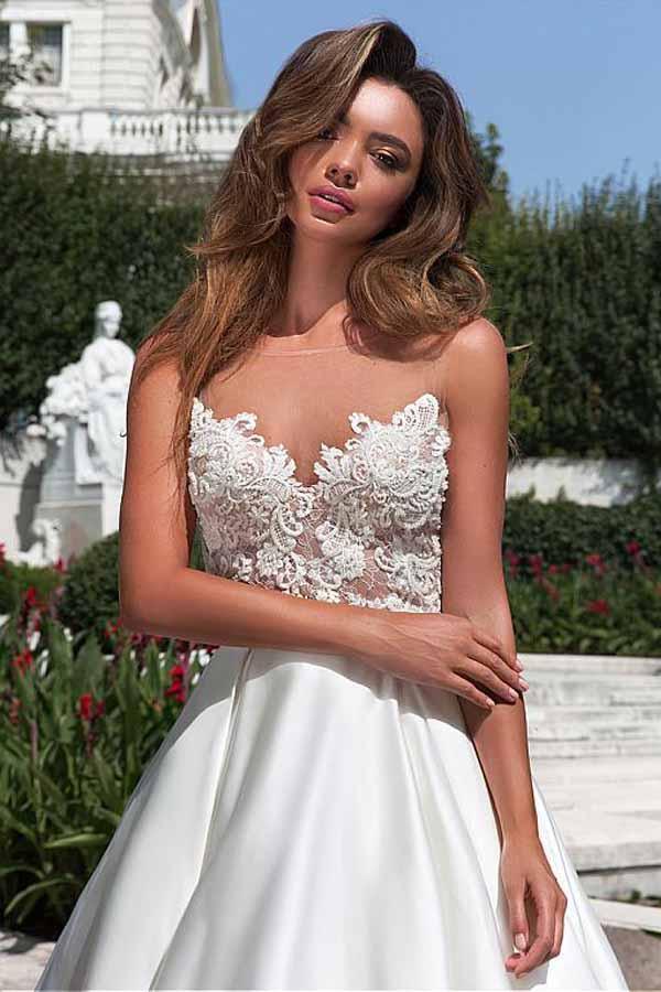 Vestido de novia corte A con escote de satén y bolsillos con apliques de encaje